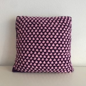 Purple and pink knitted pillow