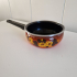 Brown saucepan with floral decor